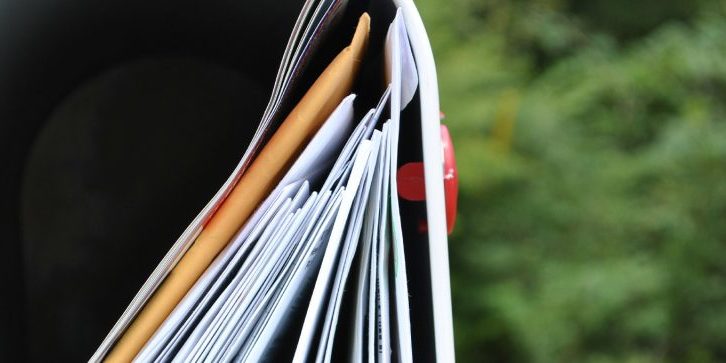 mailbox stuffed with envelopes